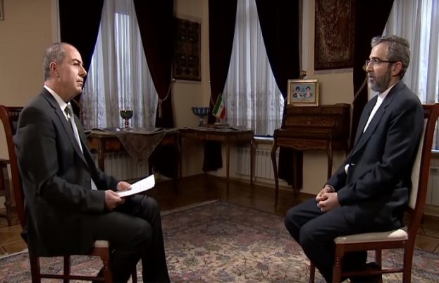 Iran’s Deputy Foreign Minister Ali Baqeri-Kani (R) speaks with Russia Today’s Arabic servicea